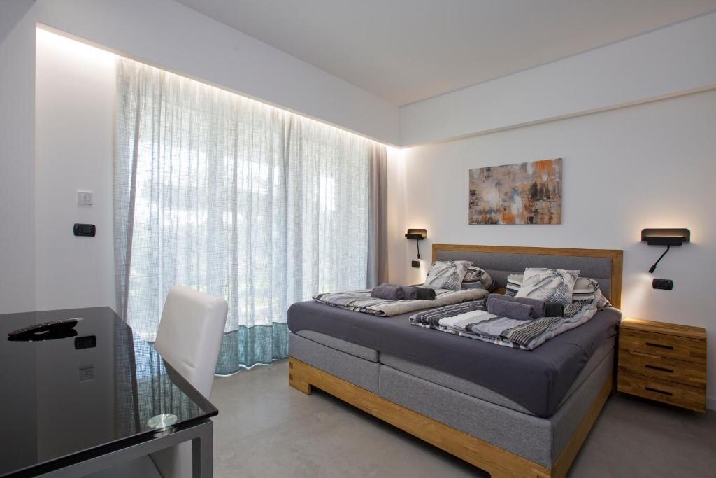Bright bedroom with large curtained window
