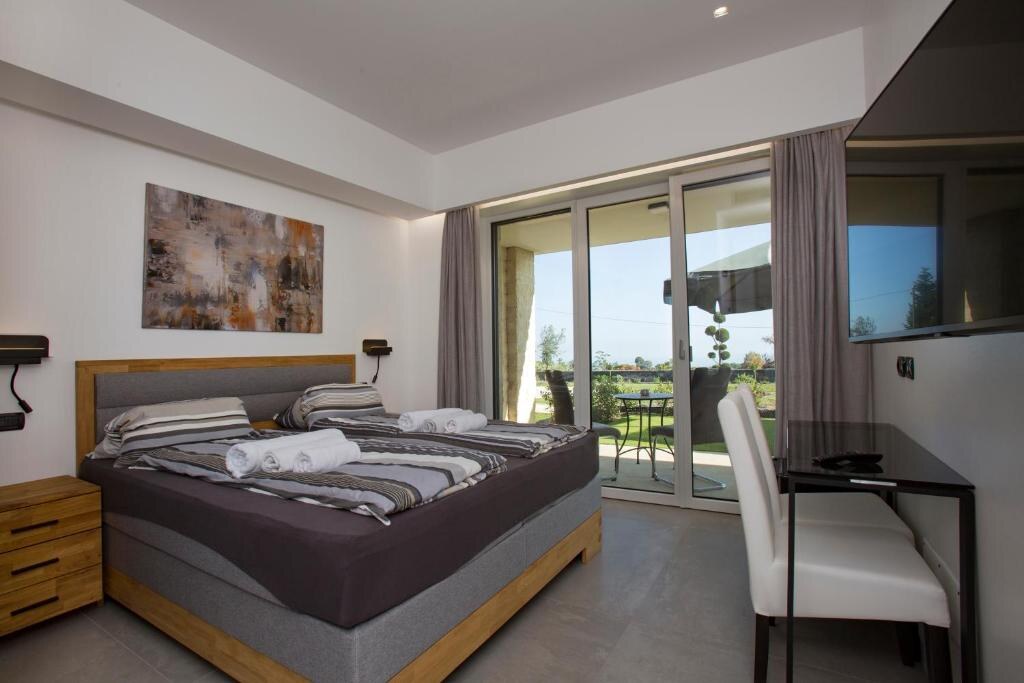 Bedroom with wooden bed frame and terrace doors