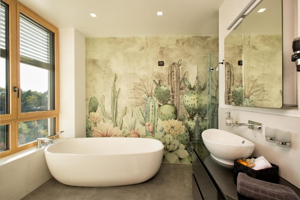 Bathroom with freestanding bath, walk-in shower and painted wall